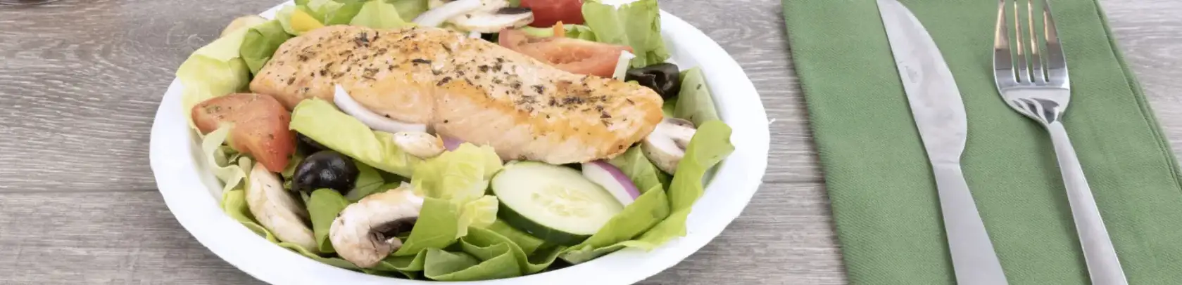 table setting for salmon on salad meal